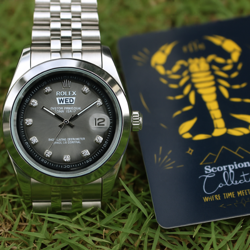 Silver watch with black dial next to a 'Scorpions Collection' card on grass